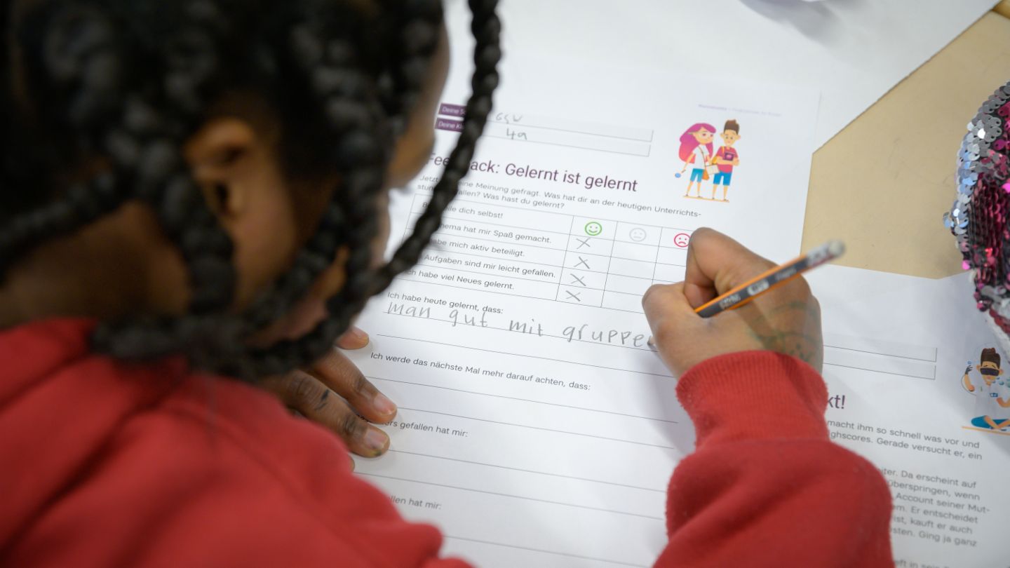 Financial education for children: Child completes a feedback form on the finlit initiative.